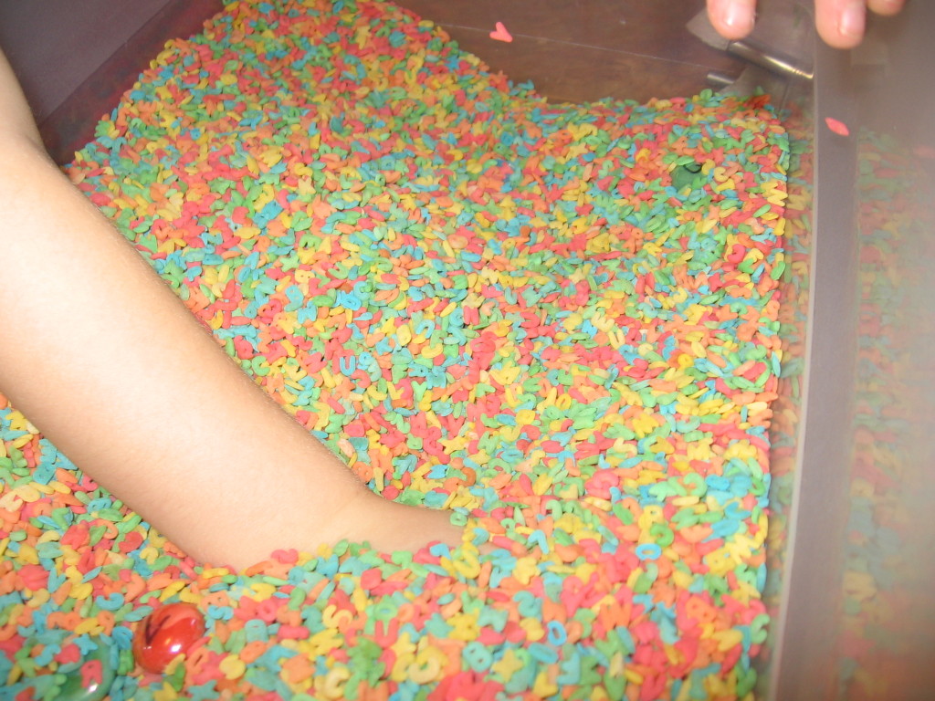 挖在彩色字母表面团箱的孩子